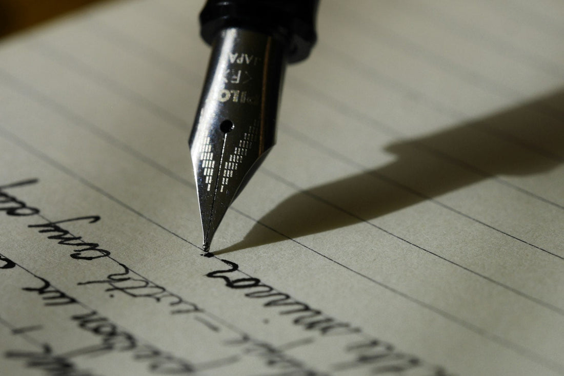 Fountain pen writing a heartfelt handwritten love letter on paper