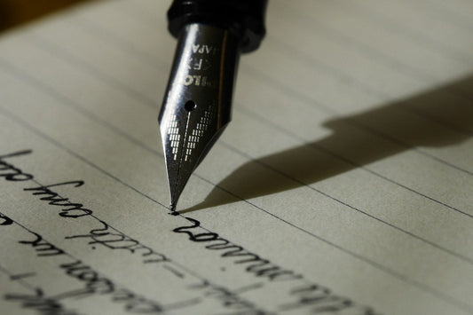 Fountain pen writing a heartfelt handwritten love letter on paper