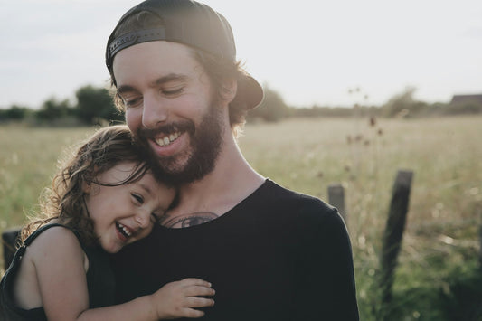 Father hugging his daughter outdoors
