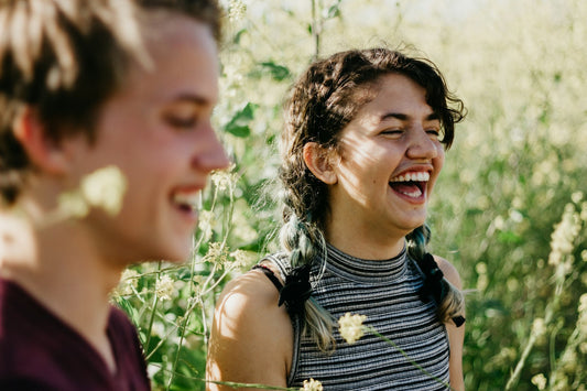 Mother and adult daughter laughing together, a moment for songs about moms