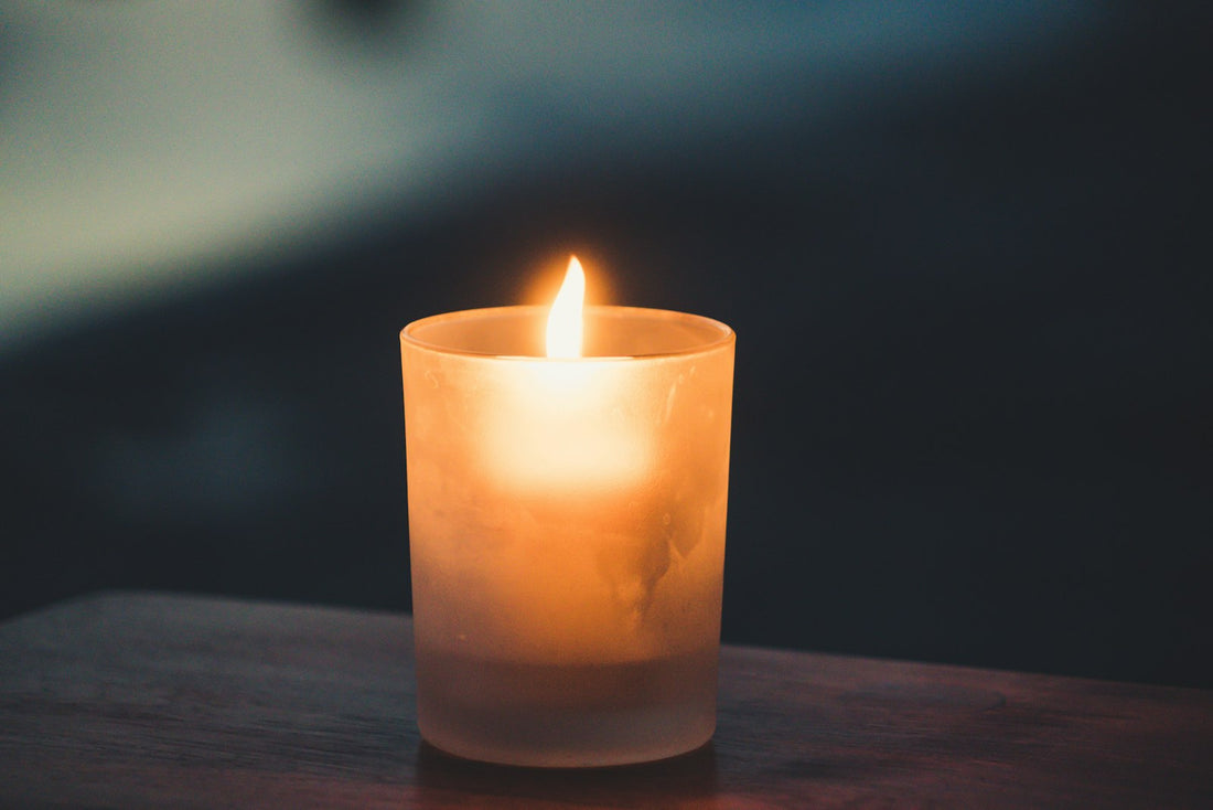 A single lit candle glowing softly