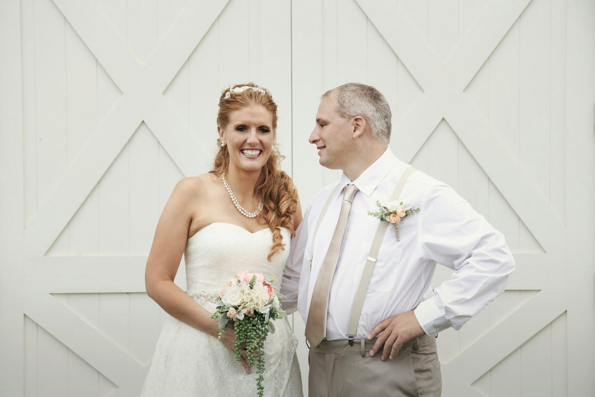 Father and bride smiling together before their father-daughter wedding dance