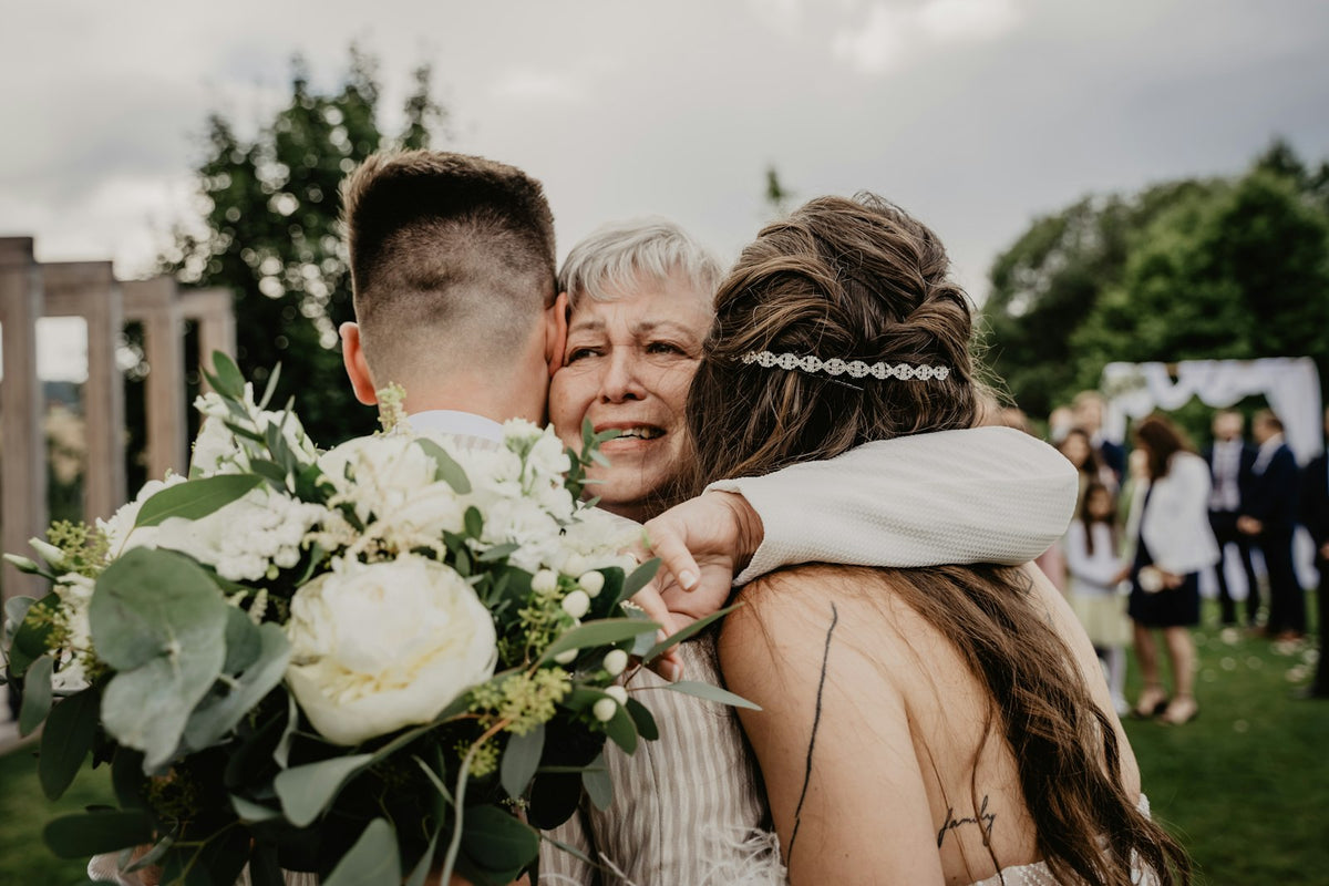 Bride hugging her mother on the wedding day after receiving a thank-you gift