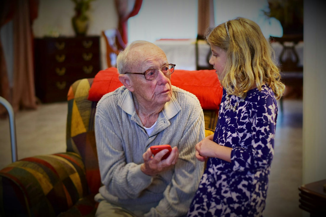Grandfather sharing stories from his life with his attentive granddaughter