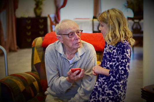 Grandfather sharing stories from his life with his attentive granddaughter