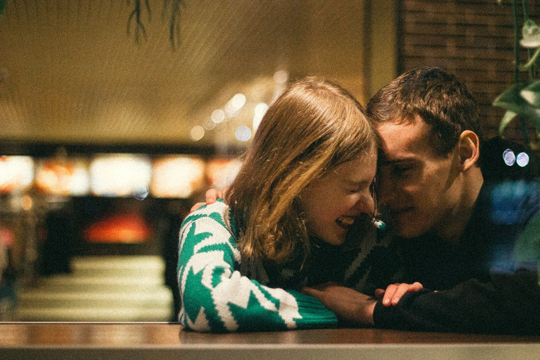 Couple sharing a cozy moment at a cafe on their one-year anniversary