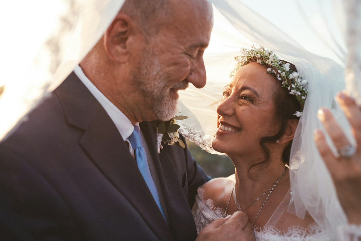 Older couple smiling together during their vow renewal ceremony