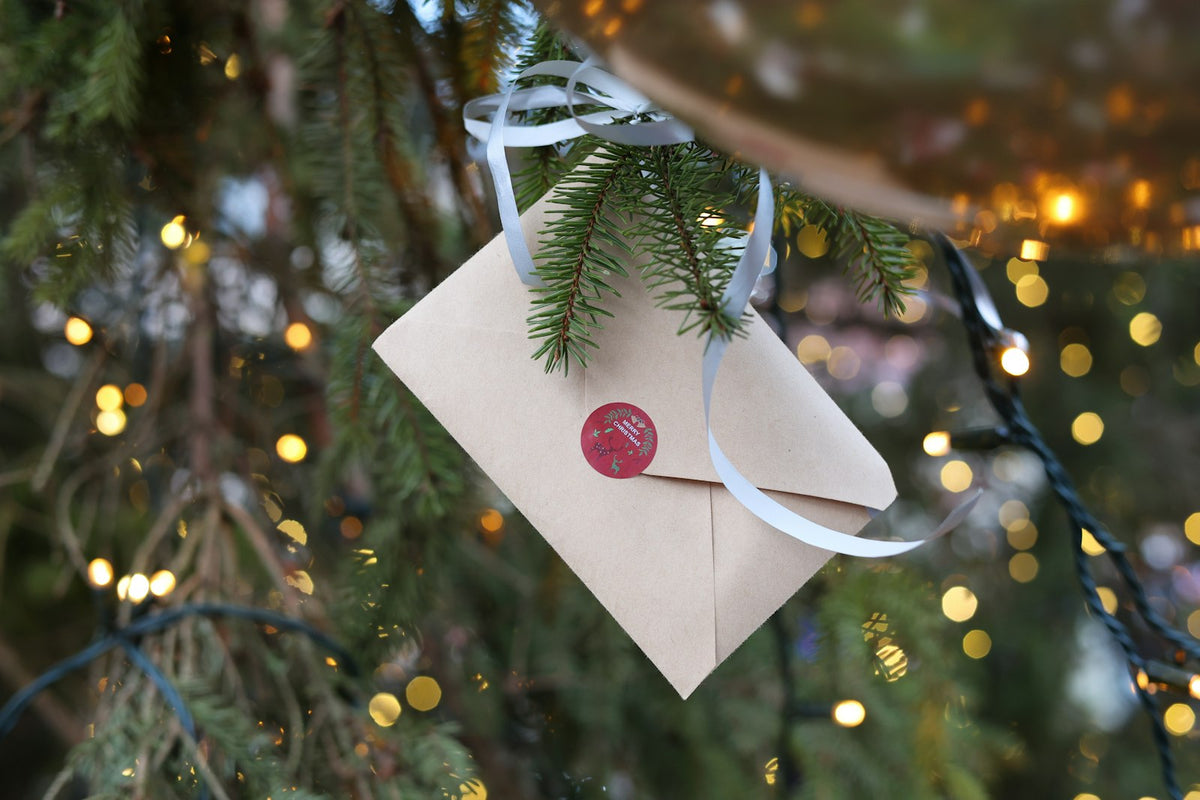 Sealed envelope hanging on a Christmas tree