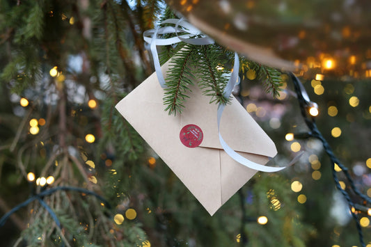 Sealed envelope hanging on a Christmas tree