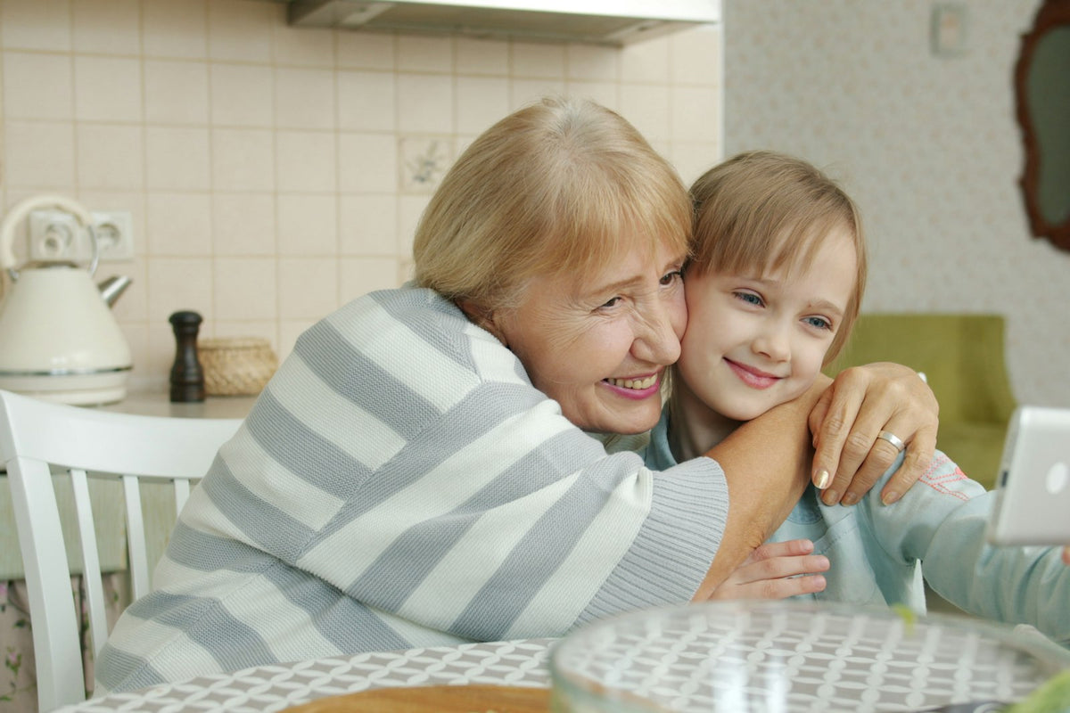 Grandmother and granddaughter smiling while taking a selfie together