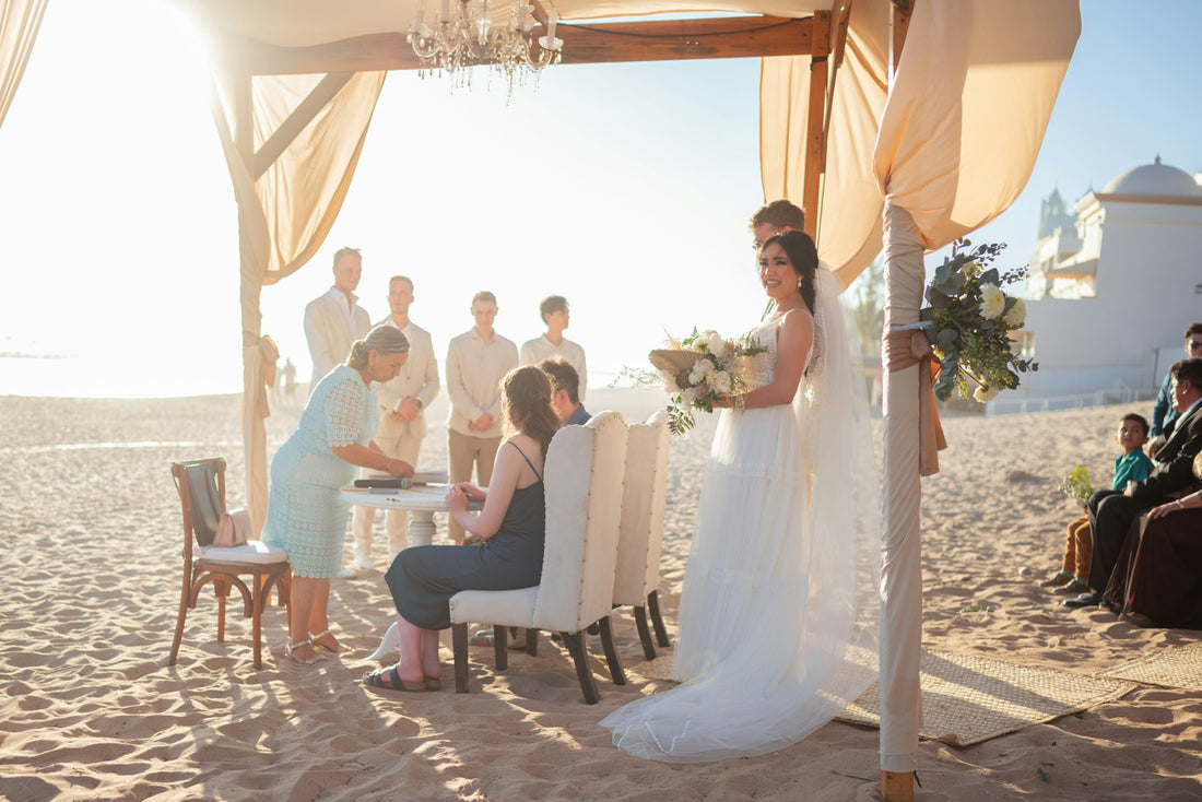 Couple exchanging their own wedding vows at a beach wedding ceremony