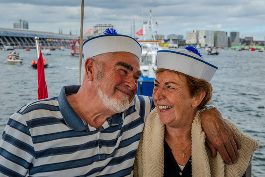Smiling older couple on a boat celebrating their 50th wedding anniversary